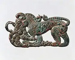 Belt plaque in the shape of a standing wolf, characteristic of nomadic artifacts of southern Ningxia and southeastern Gansu, and related to the Scythian styles of Pazyryk. 4th century BC.[103][99]
