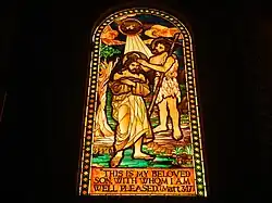 Stained glass window featuring the Baptism of Jesus