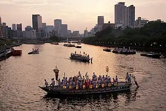 River boats on the Okawa River in Osaka at sunset. The boats are illuminated by lanterns that they carry aboard.