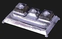 Colour photograph of a silver inkwell