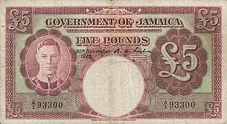 Purple coloured banknote showing image of George VI