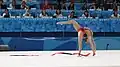 Performing a boomerang with a walkover, using a foot to help pull the ribbon (Tatyana Volozhanina)