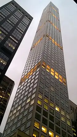 Facade of 432 Park Avenue as seen from ground level. Some windows are illuminated.
