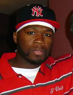 Durags, snapbacks and polo shirts were popular in the 2000s as men's wear, shown here by rapper 50 Cent in 2006