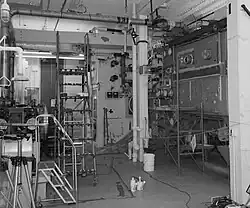 A black and white photograph of a room with a lot of industrial machinery