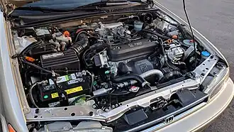 Internal combustion engine that says "programmed fuel injection" and "16-valve Honda" on the top.