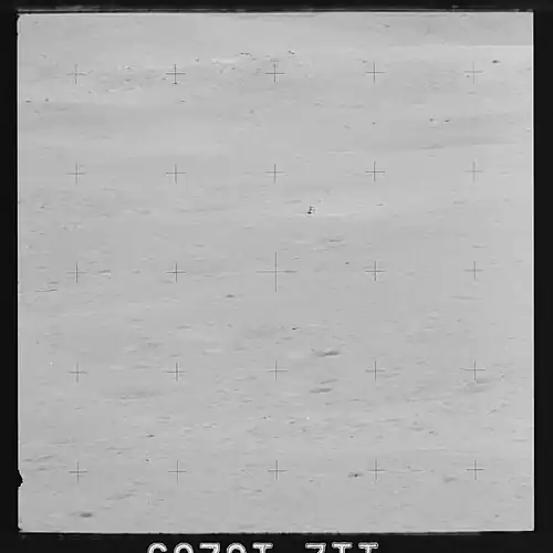 View of the lunar surface representing the Cayley Formation around the Lunar Module Orion, taken from Station 4 on Stone Mountain south of the landing point.