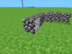 Cobblestone blocks on a flat grassy field.