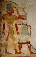 Fragment of a painted relief of Ramesses II wearing the Khepresh while being accompanied by Horus