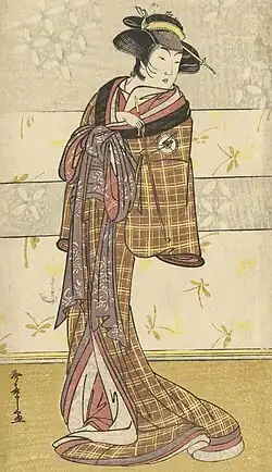 Japanese figure in a brown and yellow tartan-pattern kosode (early kimono)