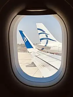 Aegean's new and old livery, on two side by side parked aircraft
