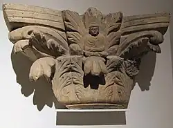 Indo-Corinthian capital, with figure of the Buddha inside acanthus leaves. Tapa Kalan.