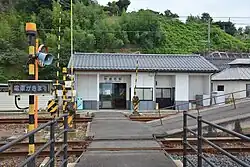 Exterior of station building showing level crossing