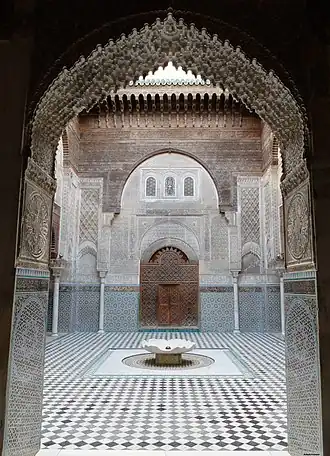 A lambrequin or "muqarnas" arch with muqarnas decoration in the Madrasa al-Attarine, Fes (1323–1325)