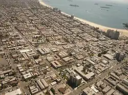 The Alamitos Beach neighborhood of Long Beach, California, looking southeast. Alamitos Avenue runs left to right across the center of the photo; Alamitos Beach is located above it, with the East Village below. 4th Street cuts from the top left corner to the bottom center; Alamitos Beach is to the right of it.