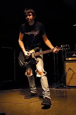 Recording engineer Steve Albini holding a guitar