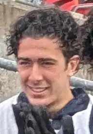 Small blurry photo of a young man in the rain