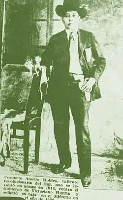 Photo of Robles from a newspaper leaning against a chair with a cigarette in his hand