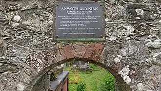 A stone arch with a plaque above it