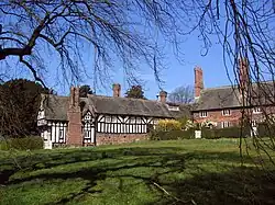 Brick terraced building and Tudor or Tudor-revival timber-framed building