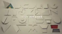 A sheet of white cardboard with a stylized alphabet cut out, the letter A in green, the letter Z in red.