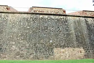 Curtain wall with embrasures and date 1812 engraved with the shots fired by Wellington's troops with cannonballs to commemorate the assault on the two bastions