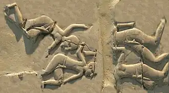 Shaven-headed men drowning, in a possible depiction of a naval battle.[41] (Front, 4th register)