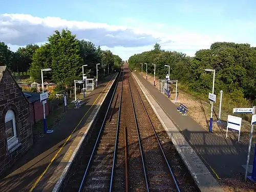 A picture depicting the two platforms of Barry Links from the footbridge over the level crossing