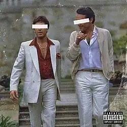 An edited still from the 1983 film Scarface, depicting a conversation between the characters Tony Montana and Alejandro Sosa, played by Al Pacino and Paul Shenar respectively, as they are walking towards the camera. Their eyes have been covered by white censor bars.