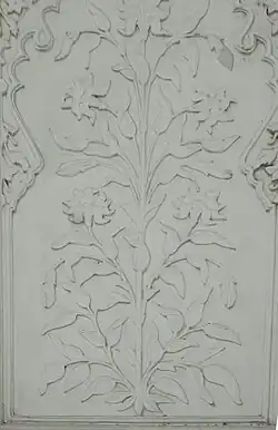 Floral designs on marble, as seen on the tomb's interior walls