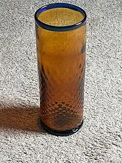 orange vase with a blue rim