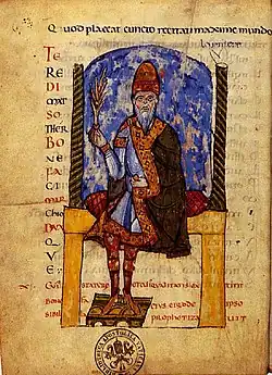 A bearded man sitting on a cushion