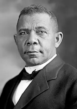 Formal portrait photograph of an African American man, wearing a suit