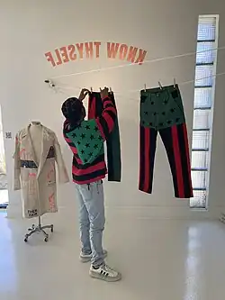 Artist Brandon Breaux and flag artworks at his solo show BIG WORDS at Blanc Art Gallery in Chicago