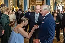 Princess Charlene of Monaco curtsying to King Charles III