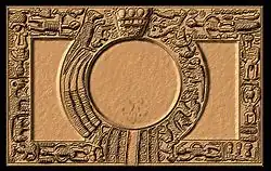 A tray with elaborately carved borders, placing a circle within a rectangle.