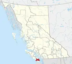 A map of British Columbia depicting its 29 regional districts and equivalent municipalities. One is highlighted in red.