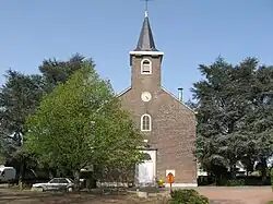Religious building in brick with trees.