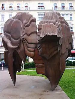 a tall open patinated bronze sculpture