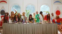 Camila Cabello is sitting next to the dinner table at the family party