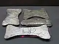 Three silver ingots and a rough piece of silver