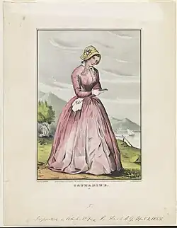 19th century picture of a lady with a pink dress, white skin, and brown hair covered by a bonnet, standing on a brown and green soil with green valleys and water visible in the background.
