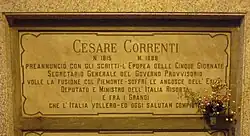 A marble gravestone on the wall of a crypt