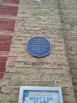 Blue plaque reads 'Charles Haddon Spurgeon "The Prince of Peachers" Began his ministry here in 1851'