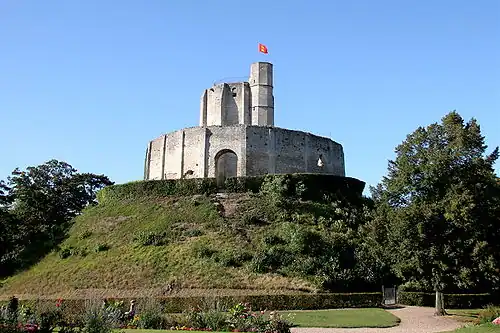 The polygonal donjon at Gisors, France, on a motte with an encircling wall.