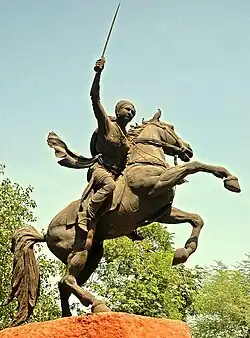 Statue of the Rani of Jhansi with a sword outstretched sitting on a rearing horse
