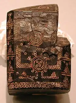 An 8th–10th century King (Shah) carved of jet. In the Islamic style, it is an abstract representation, decorated with dot-and-circle devices.