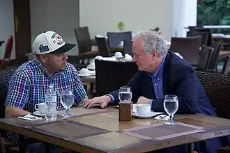Chris Van Hollen and Kilmar Ábrego García talking at a table