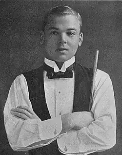 Claude Falkiner, standing with his arms crossed