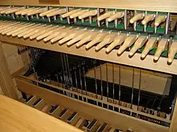 A wooden keyboard of batons connected to a pedal board
